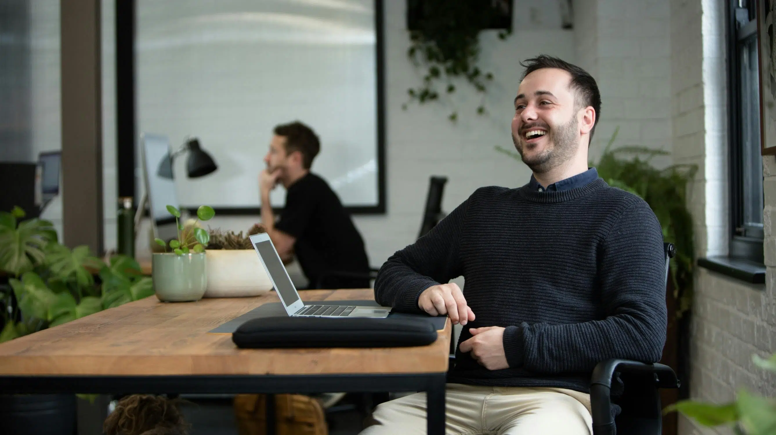 Tyron laughing at his desk